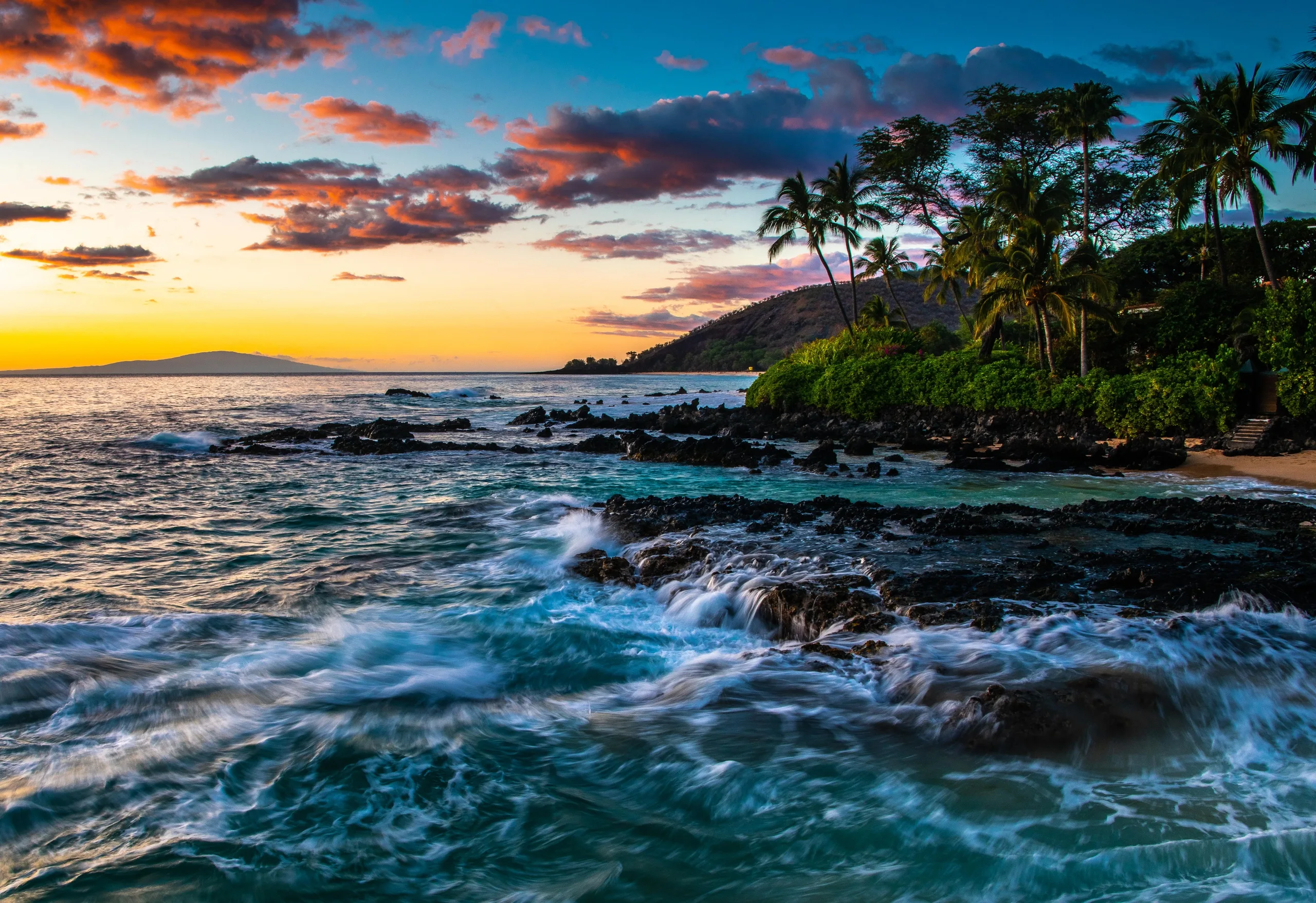 Sunrise over Ho'okipa Beach with surfers in water