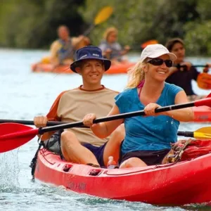 Kayakers paddling gently on calm river waters