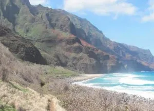 Adventurers trekking steep Kaua'i mountain trail