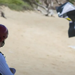 Two people sharing kiteboarding lesson with instructor