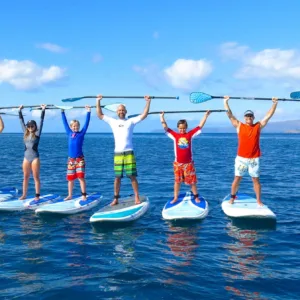 Beginner paddleboarders learning on calm ocean