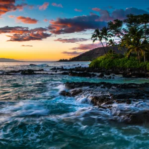 Sunrise over Ho'okipa Beach with surfers in water