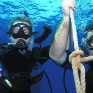 Small group receiving private scuba diving instruction