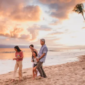 Family posing for photos on a Maui beach