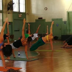 Participants practicing yoga on beach during retreat