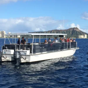 Private catamaran cruising along Honolulu coastline