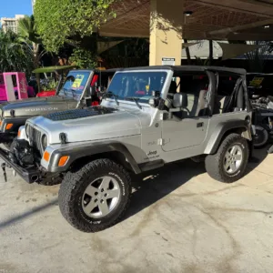 Vintage open-air Jeep parked near Waikiki beach